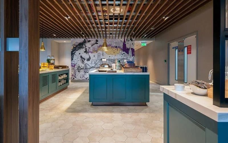 Buffet area with teal counters and a detailed feature wall
