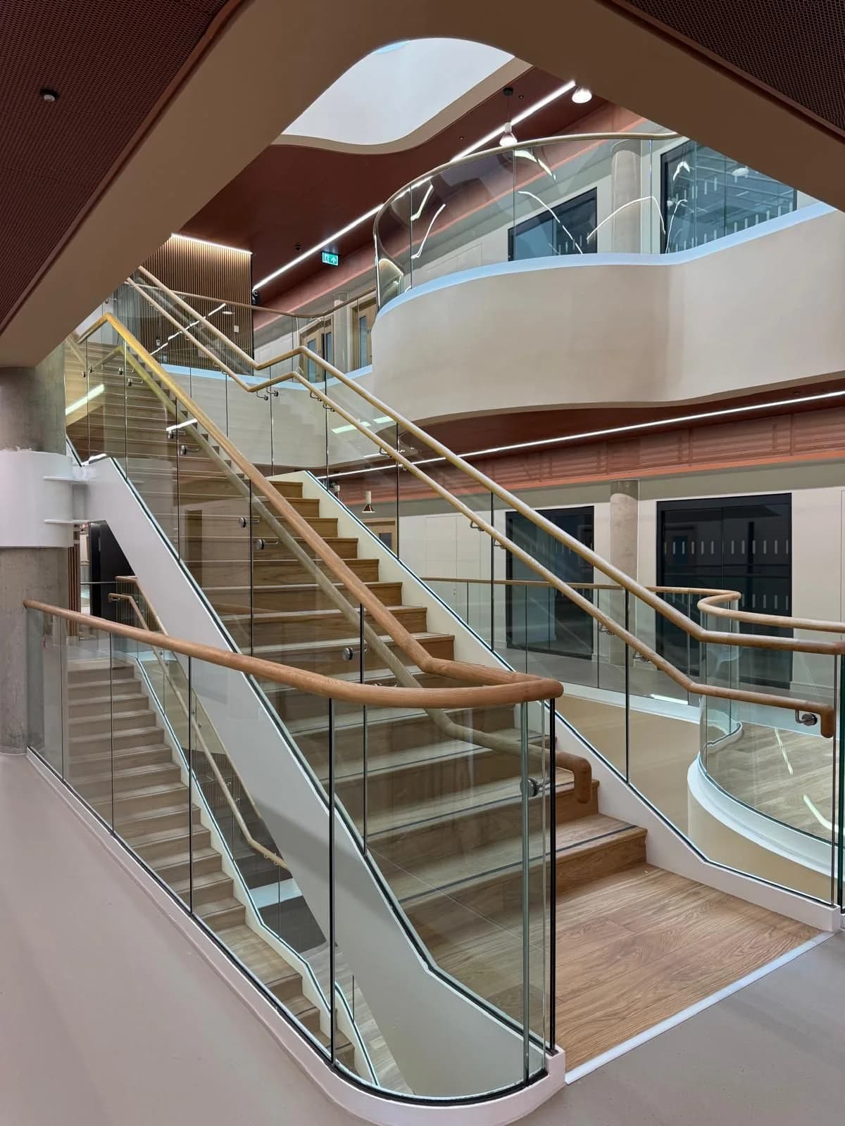 Detailed view of the completed timber and glass central staircase